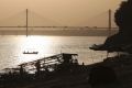 Boats are silhouetted against the sun's reflection in the River Yamuna, in Allahabad, India.