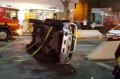 The car that rolled at the corner of Bourke and Swanston streets, on its side.