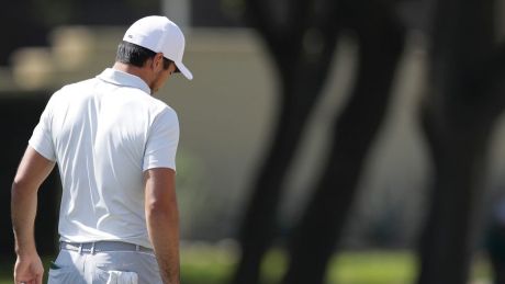 Defending champion Jason Day, right, walks down the seventh hole after he conceded to Pat Perez.