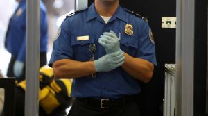 A TSA agent waits for passengers.