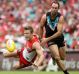 Out-contested: Luke Parker of the Swans falls as he competes for the ball with Matthew Broadbent.