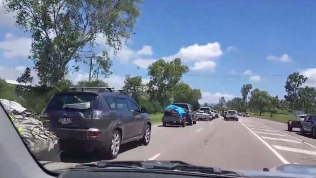 Traffic queues to the dump in Townsville as residents get rid of debris ahead of the arrival of Cyclone Debbie.