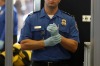 A TSA agent waits for passengers.