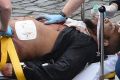 A man police have identified as Khalid Masood is treated by emergency services outside parliament.