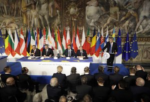 Italian Prime Minister Paolo Gentiloni, right, makes the opening address during a meeting at the Orazi and Curiazi Hall in the Palazzo dei Conservatori during an EU summit in Rome on Saturday, March 25, 2017.