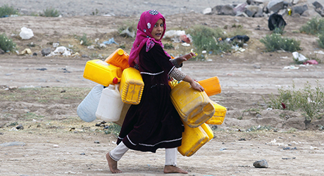  A Yemeni girl carries empty jerry-cans before collecting water from a donated water-tap, on the outskirts of Sana'a, Yemen, 22 March 2017.  EPA/YAHYA ARHAB