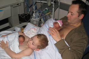 The dad and son each held one of the twins skin-to-skin. 