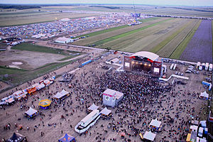 Music festival in Nickelsdorf, Austria, picturing both the main stage and the camping grounds on the farm behind.