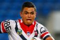 On the burst: Latrell Mitchell takes on the Titans defence.