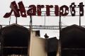 A Pakistani police officer stands on the roof of Marriott hotel in Islamabad a day after a truck bombing  on September ...