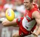 Out-contested: Luke Parker of the Swans falls as he competes for the ball with Matthew Broadbent.