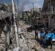 Residents carry the bodies of several people killed during fights between Iraq security forces and Islamic State on the ...