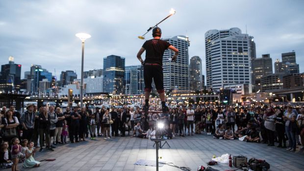 Daniel Nimmo performs his circus stunt show in front of a crowd in Darling Harbour.