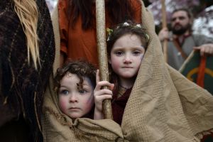 Forrest Bear Burns (L) and Willow Burns (R) huddle under their mother's shawl before they join their father, Marty Burns ...