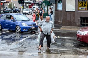 Gutters were overflowing in Sydney Road, Brunswick, yesterday.