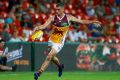 Tom Rockliff of the Lions takes a kick during the round one AFL match between the Gold Coast Suns and the Brisbane Lions ...