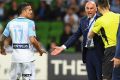 Anger management: The fourth official intervenes as Tim Cahill and Kevin Muscat exchange words.