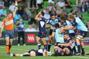 Match winner: Waratahs players celebrate Dave Horwitz's try to seal the match against the Rebels in Melbourne on Friday ...