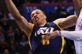 Utah Jazz guard Dante Exum (left) shoots in front of Oklahoma City Thunder guard Russell Westbrook.