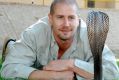 Venom expert Bryan Fry with a black cobra in Pakistan.