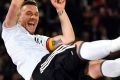 Germany's Lukas Podolski is thrown up in the air by his teammates after the friendly in Dortmund.