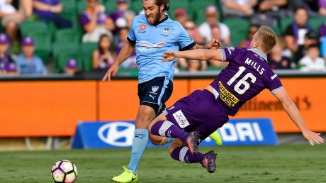 PERTH, AUSTRALIA - MARCH 26: Joseph Mills of the Glory contests the ball with Joshua Brillante of Sydney FC during the ...