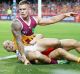  Lion Dayne Beams is tackled by Gary Ablett at Metricon Stadium on Saturday night.