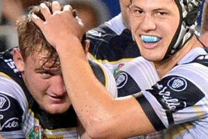 Coen Hess of the Cowboys is congratulated by team mates after scoring a try.