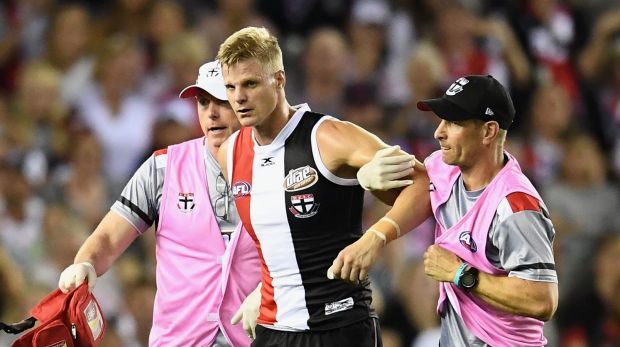 Nick Riewoldt of the Saints is helped onto the stretcher after hurting his knee.