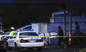 A body is removed as police work at the Cameo club after a fatal shooting, Sunday, March 26, 2017, in Cincinnati.