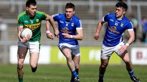 Cavan's Tomas Corr and Gerard Smith tackle Kerry's Jack Barry