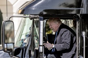 President Donald Trump pretends to drive as he gets in an 18-wheeler as he meets with truckers and CEOs regarding healthcare on the South Lawn of the White House, Thursday, March 23, 2017, in Washington.