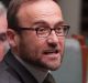 Adam Bandt with a solar panel during question time at Parliament House in Canberra on Monday 13 February 2017. Photo: ...