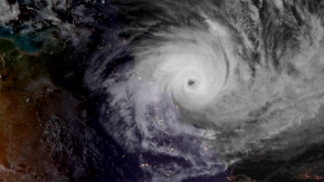 The eye of Cyclone Debbie as seen from space as the sun sets on Monday.