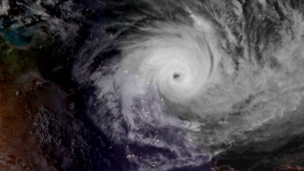 The eye of Cyclone Debbie as seen from space as the sun sets on Monday.