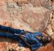 Richard Hunter lies next to a 1.7 metre dinosaur footprint belonging to a sauropod. The scale Richard is holding is 40cm ...