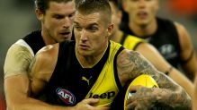 Dustin Martin is tackled by Bryce Gibbs during the opening match of the 2017 AFL season between Richmond and Carlton at ...