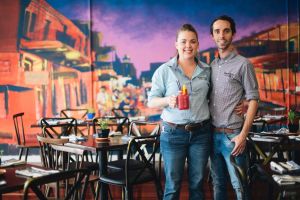 Owner Alicia Ingram and manager Mitch Liehr in the new Bourbon Street Kitchen, in front of the mural by street artist Byrd.