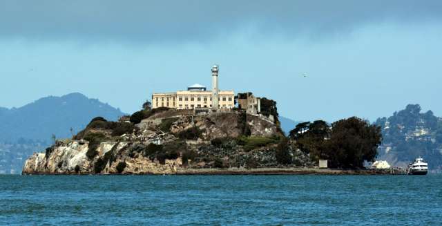 Alcatraz Island surrounded by the sea and clouds.