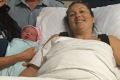 Paramedics with the mother who delivered a baby girl at Cannonvale ambulance station during Cyclone Debbie.