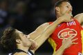 The Suns' Steve May gets some close attention from Magpie Darcy Moore in round 22.