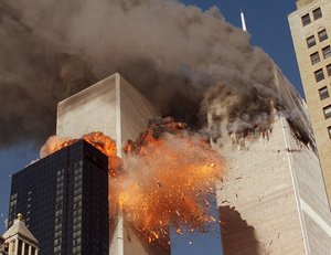 In this Sept. 11, 2001, file photo, smoke billows from one of the towers of the World Trade Center and flames as debris explodes from the second tower in New York.