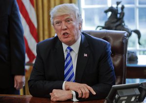 President Donald Trump addressing members of the media regarding the health care overhaul bill, Friday, March 24, 2017, in the Oval Office of the White House in Washington.