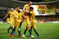 Mathew Leckie of the Socceroos celebrates with teammates after scoring the second goal against the United Arab Emirates ...