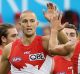 SYDNEY, AUSTRALIA - MARCH 25: Sam Reid of the Swans celebrates with his team mates after kicking a goal during the round ...