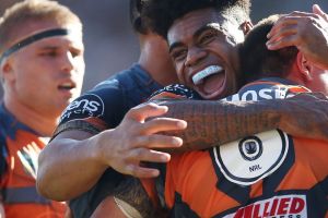SYDNEY, AUSTRALIA - MARCH 26: Mitch Moses of the Tigers celebrates scoring a try with team mate Kevin Naiqama of the ...