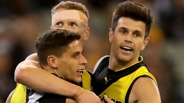 Up and about: Trent Cotchin and the Tigers celebrate after the skipper kicked a goal at the MCG.