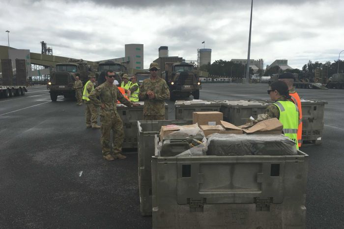 ADF workers pack emergency cyclone supplies into shipping containers.