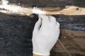 A restoration expert treats a giant piece of wood believed to have been from one of King Khufu's boats.