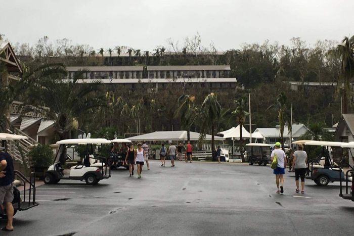 Holidaymakers walk around Hamilton Island after Cyclone Debbie.